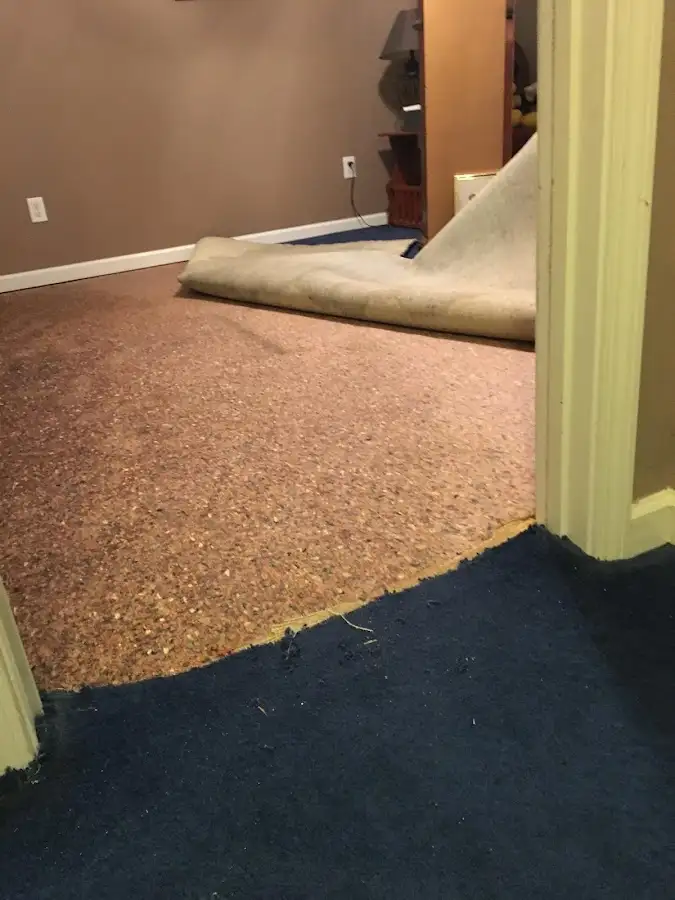 Carpet pad removal revealing water damage during Drying & Dehumidification in Parkersburg